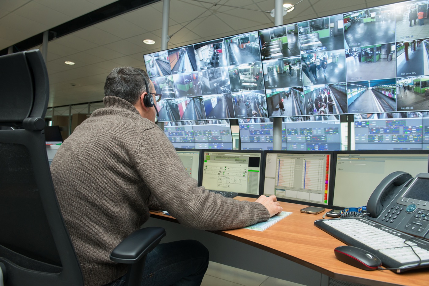 Opérateur en centre de télésurveillance devant un mur d’écrans